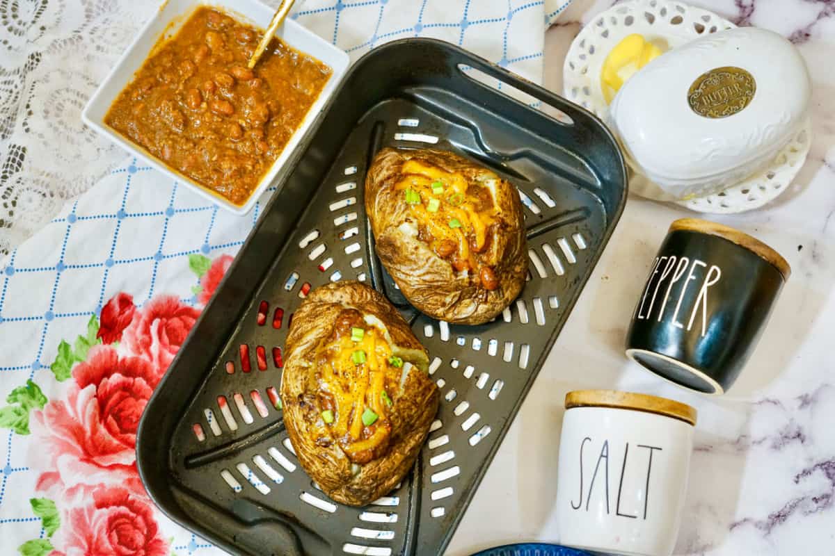 air fryer  potatoes with chili and cheese on pan