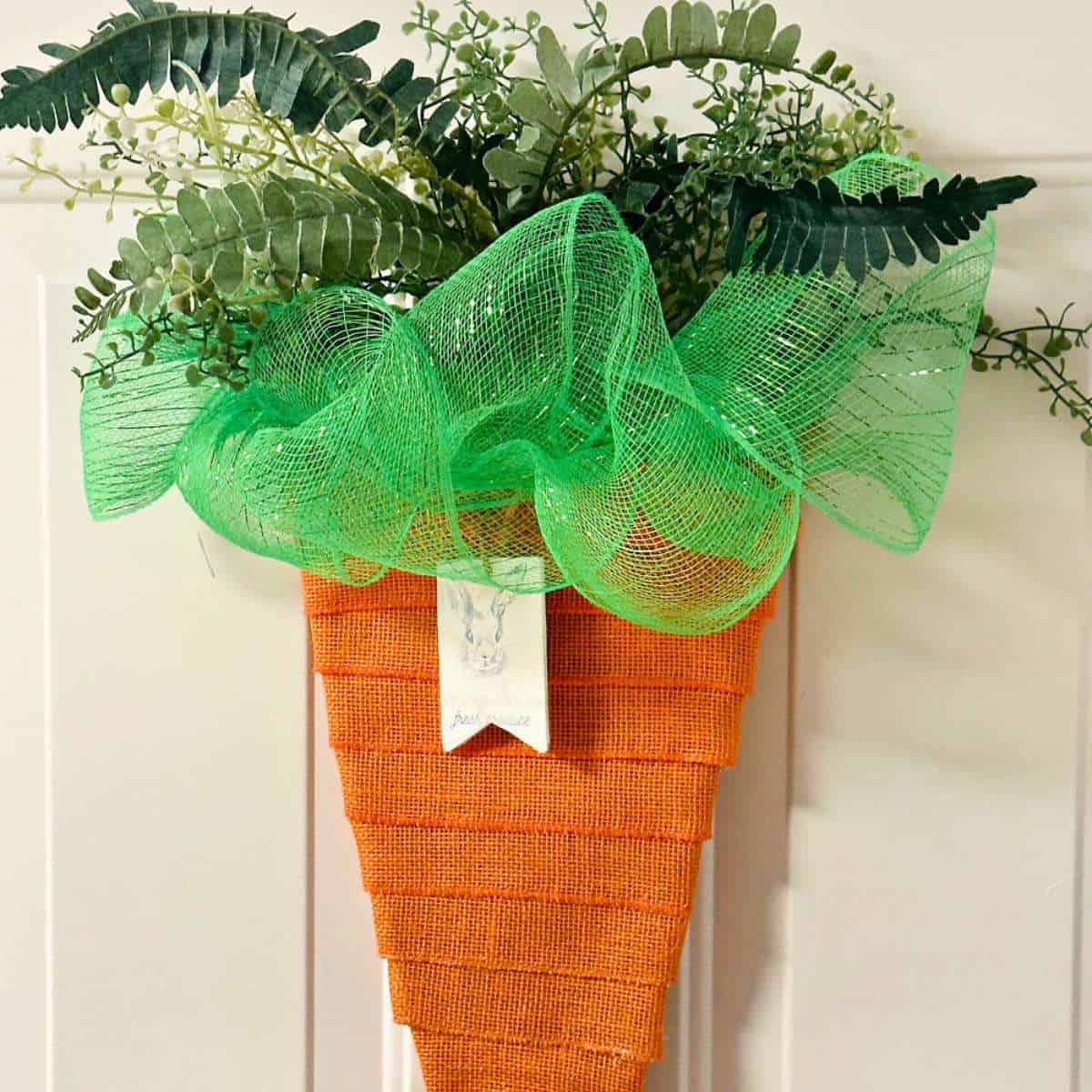 close up of diy carrot wreath with free printable tag