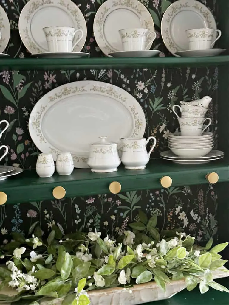 china displayed on painted hutch