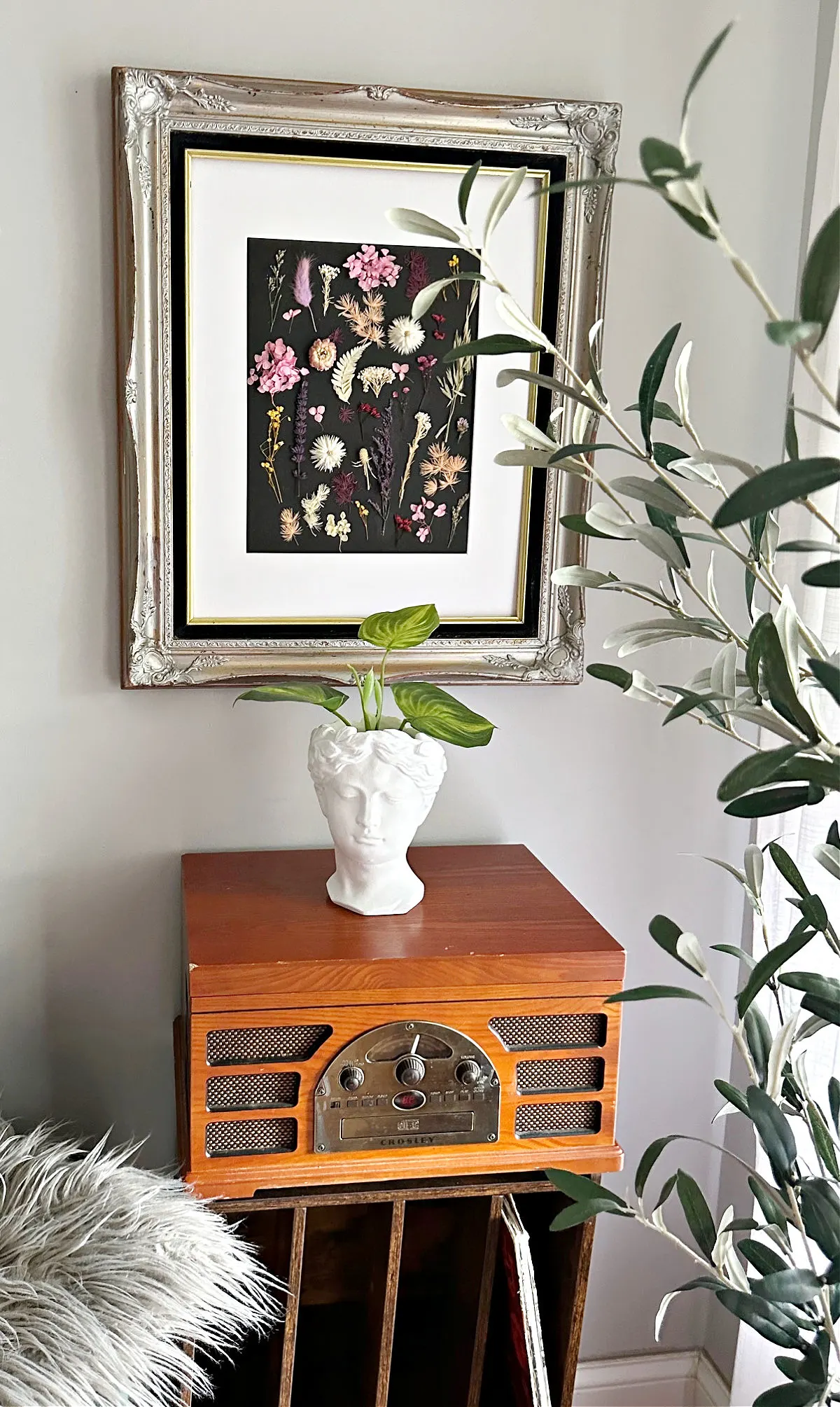 full size image with pressed dried flower art and record player.
