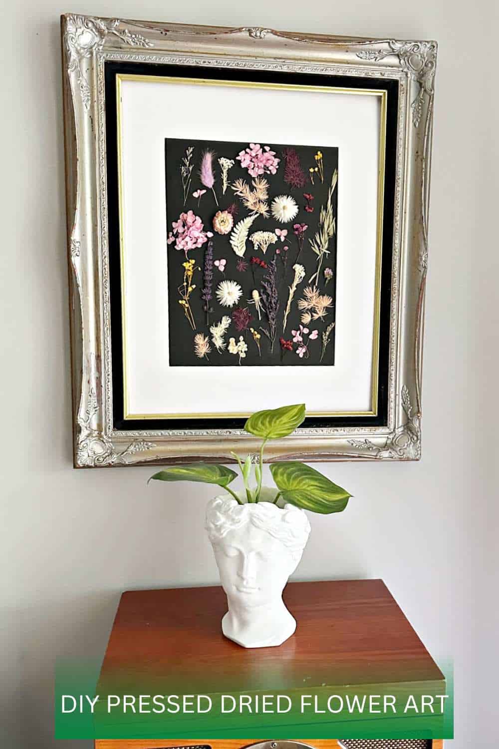 pin image with pressed flower wall art and plant.