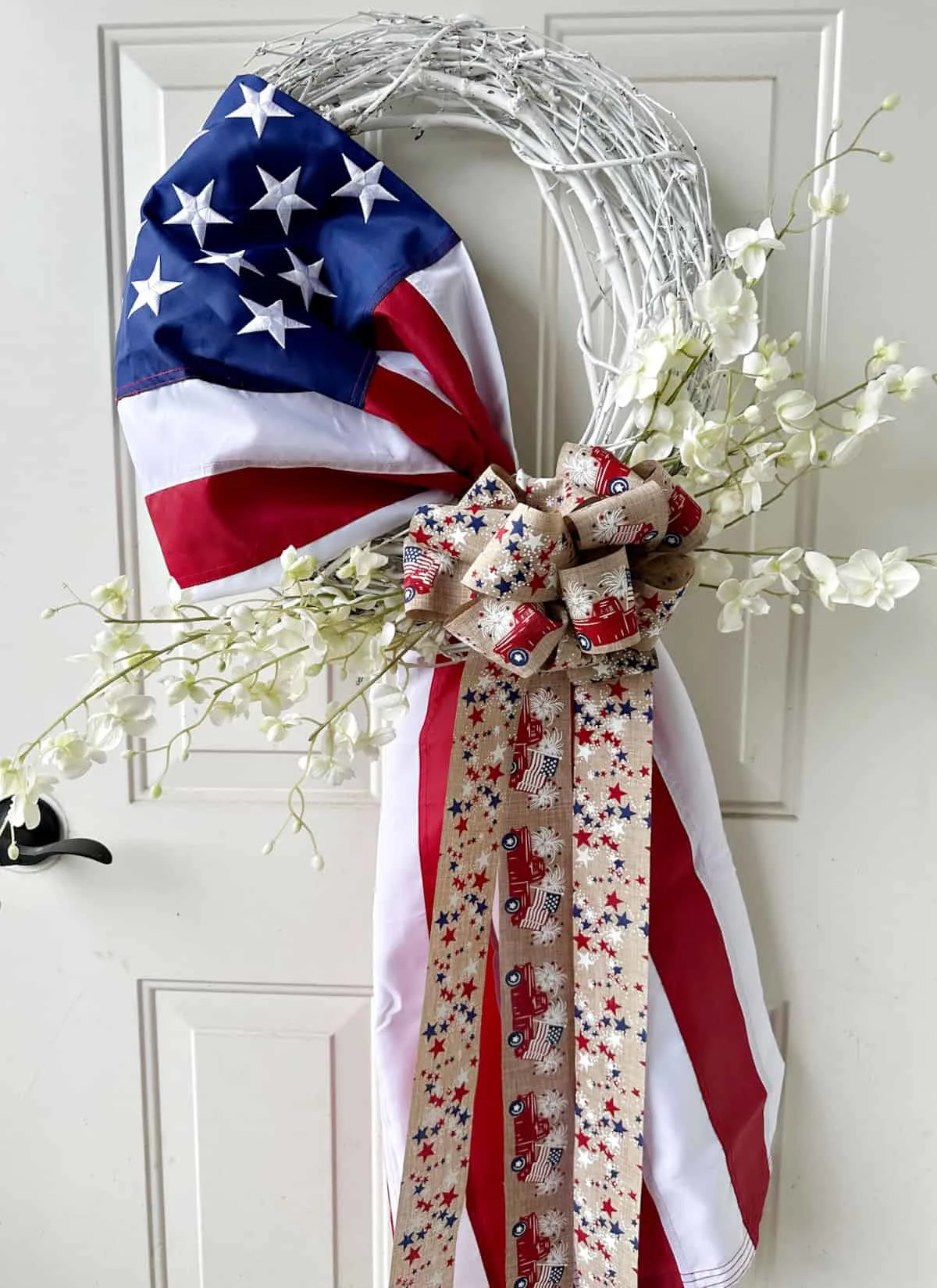 red white and blue American flag wreath on door.