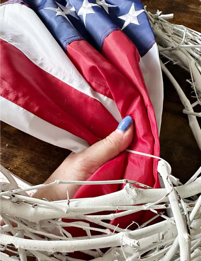 securing flag to grapevine wreath.