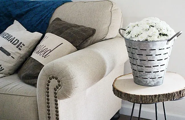 white mums in olive bucket