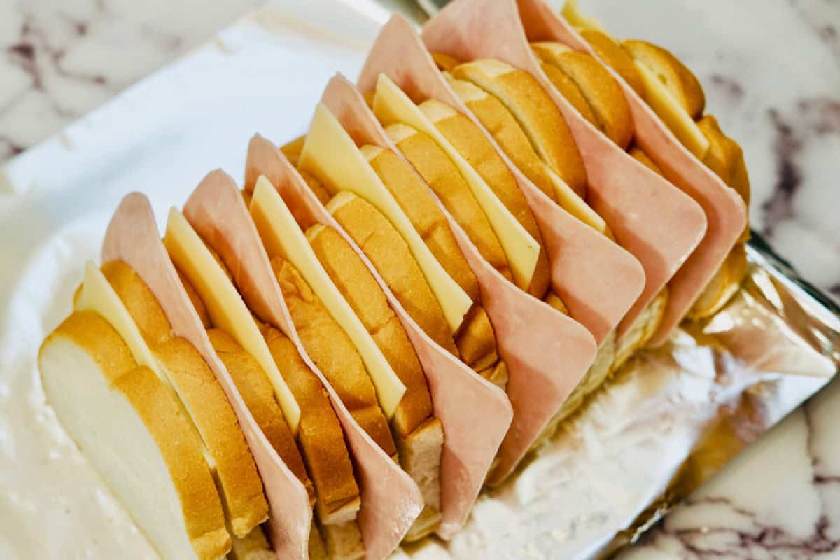 adding ham to pull apart bread