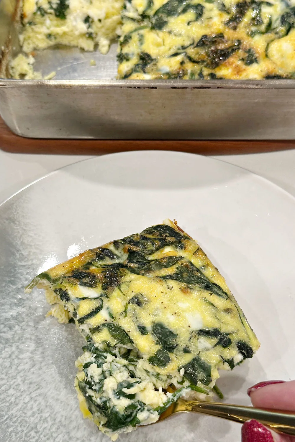 taking a piece of frittata