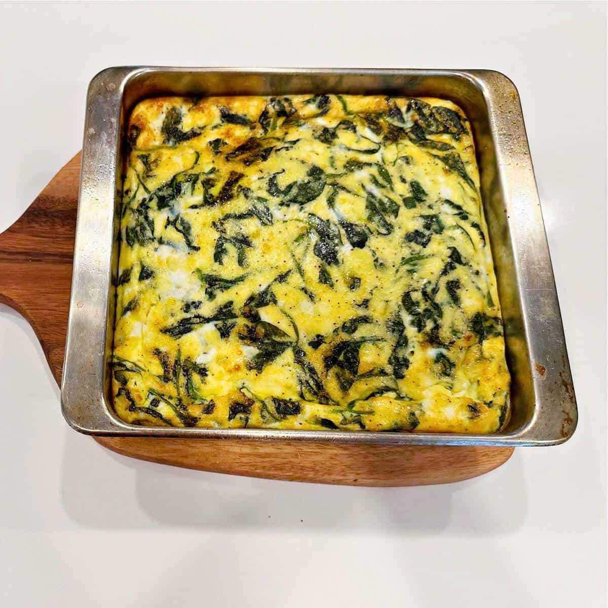 spinach and feta frittata on wood board