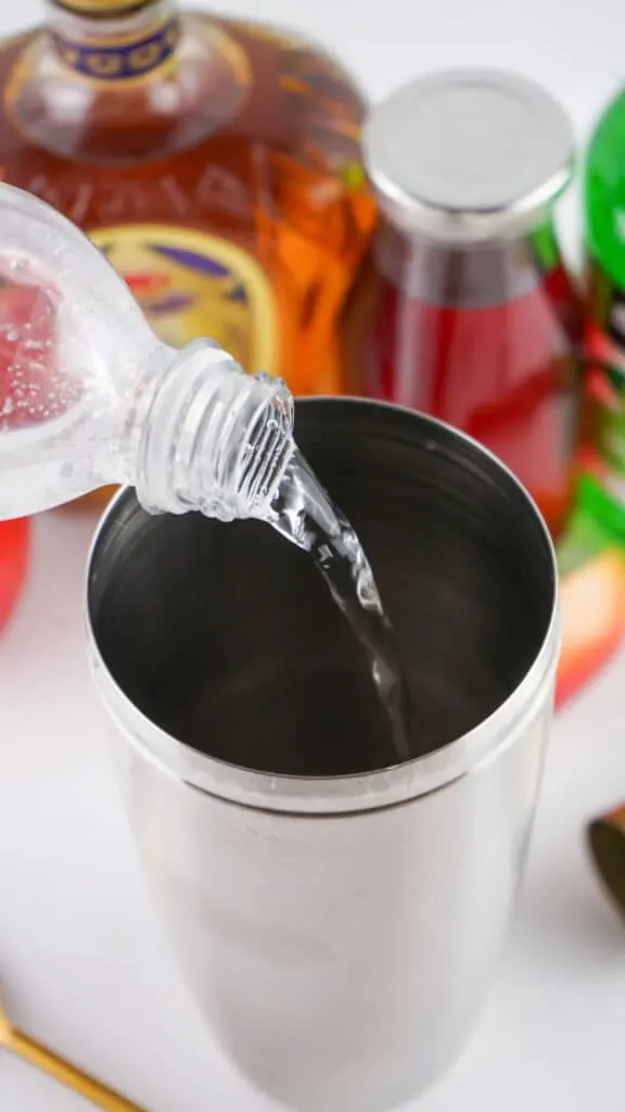 adding bubbly water to shot