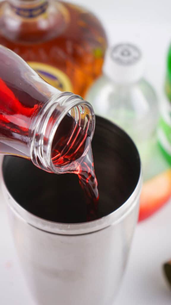 pouring cranberry juice in shaker