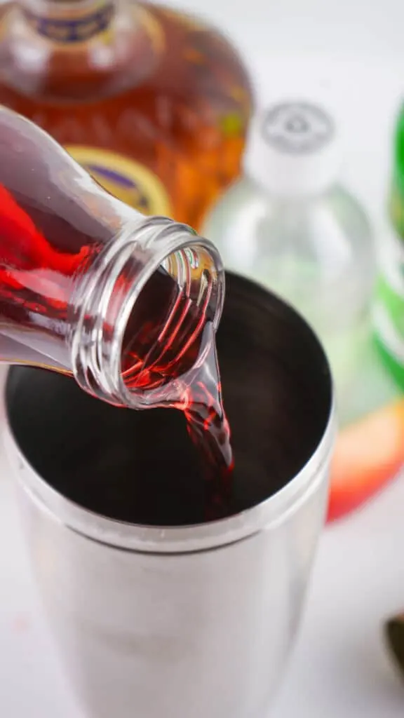 pouring cranberry juice in shaker