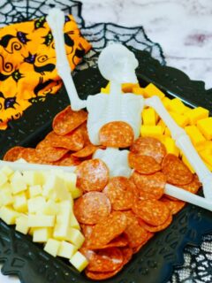 Halloween charcuterie board skeleton with cheese and pepperoni