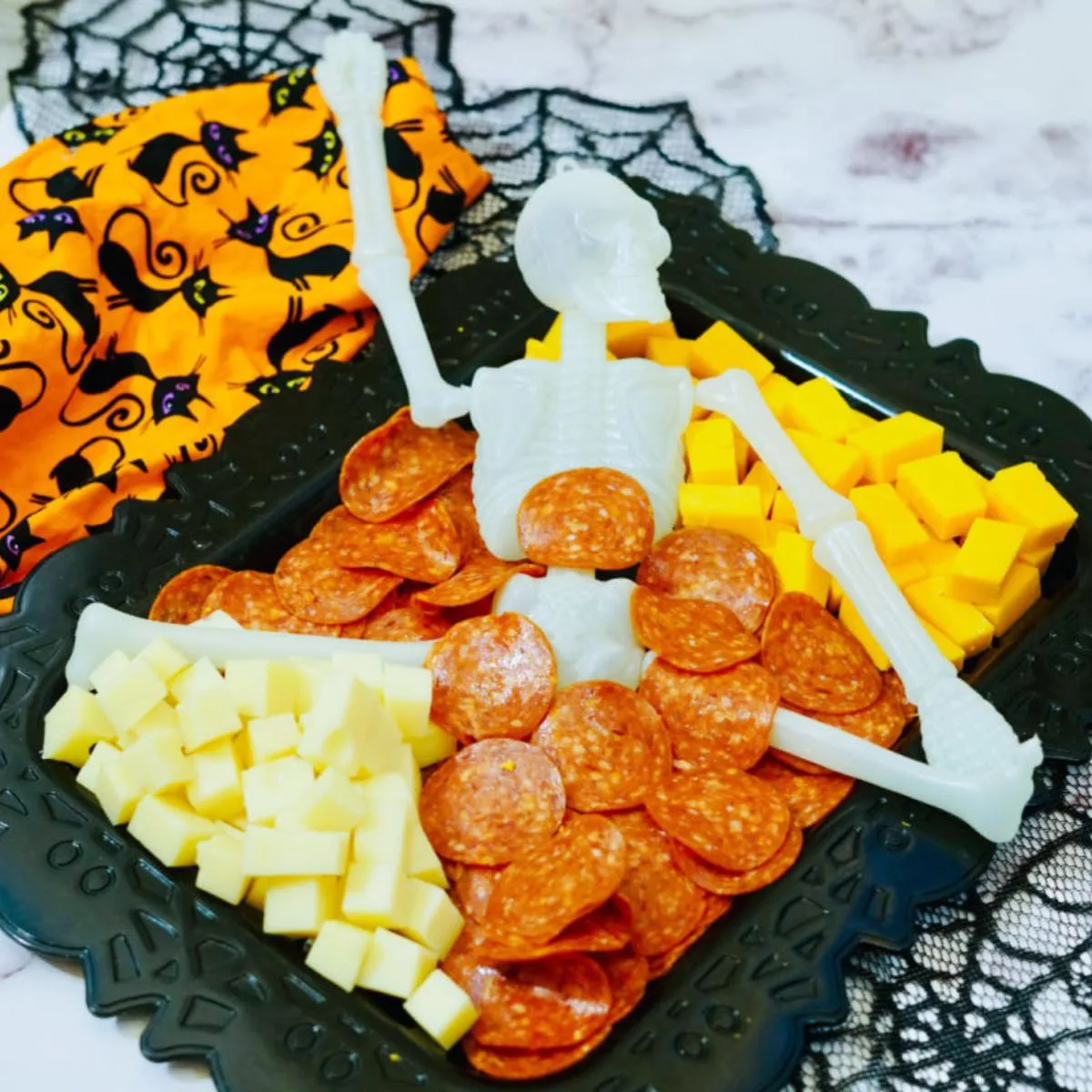 Halloween skeleton charcuterie board with dollar tree supplies