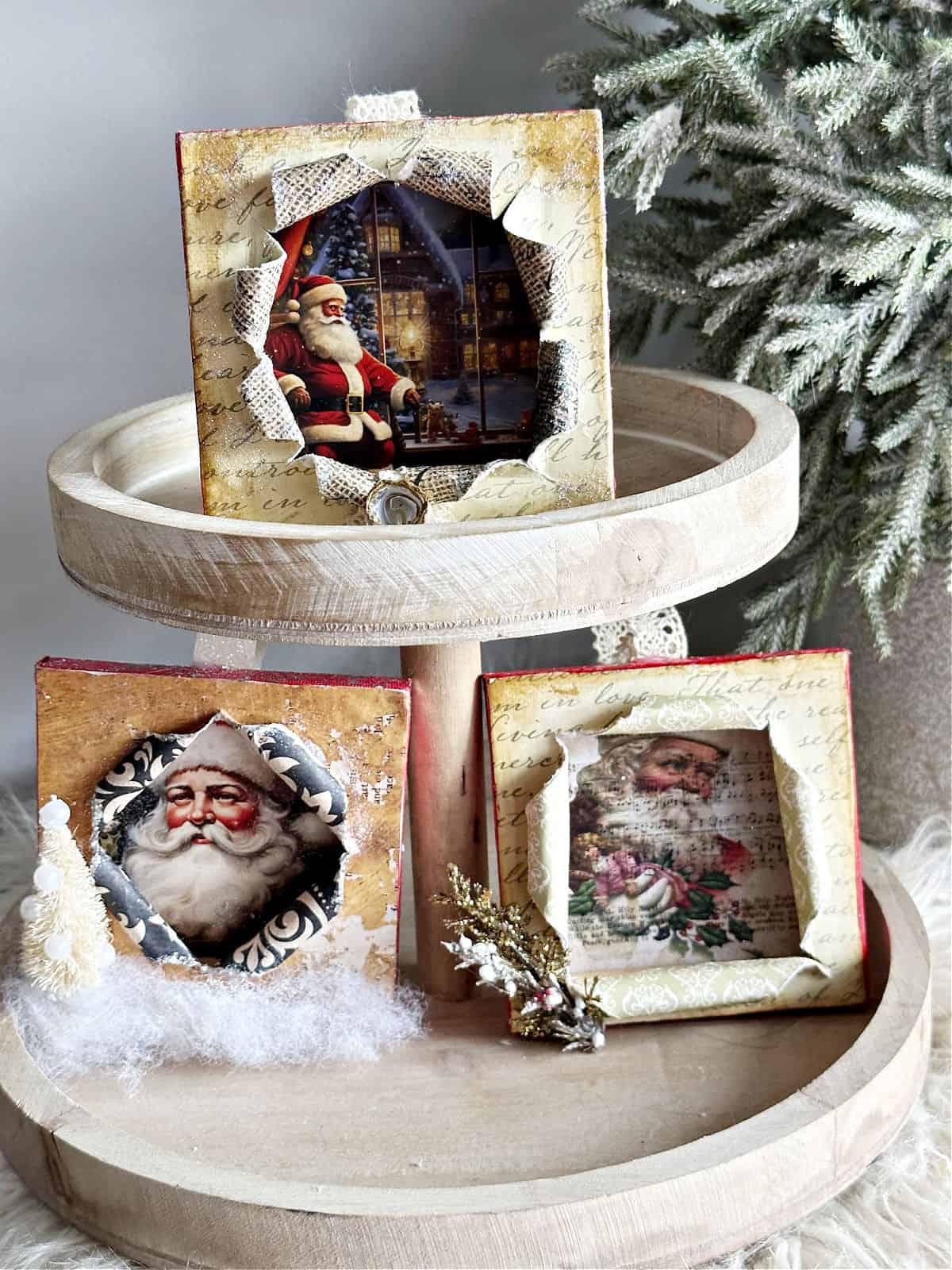 mini busted canvas Santa ornaments on tiered tray