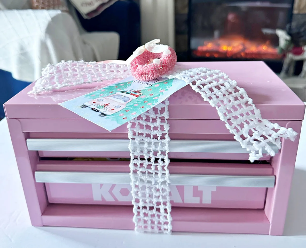 Pink tool box snackle box tied with ribbon and gift tag