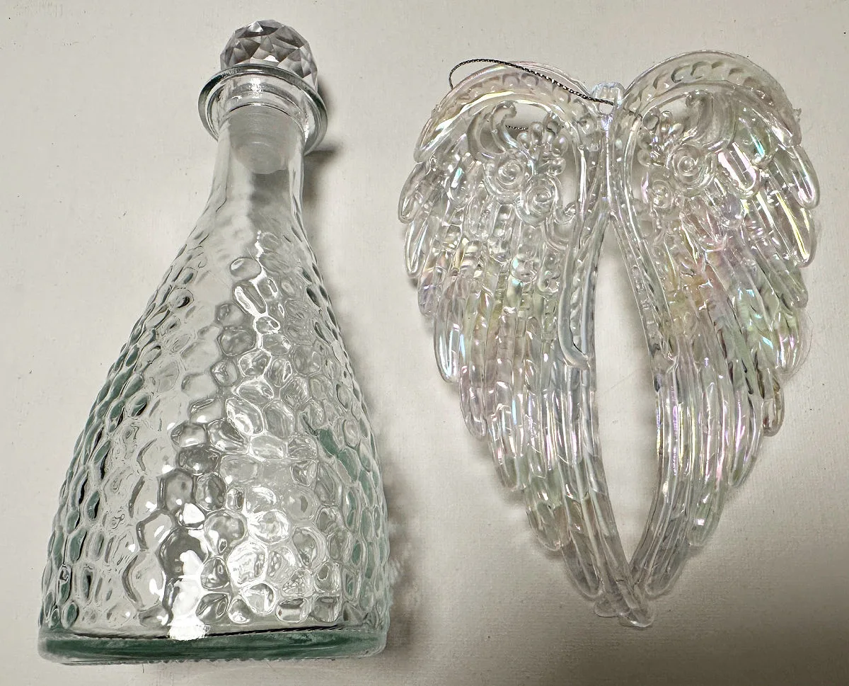 glass bottle and angel wings