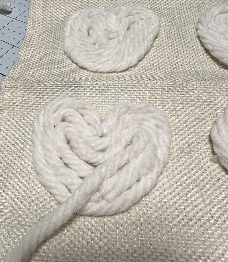 adding yarn to pillow for hearts