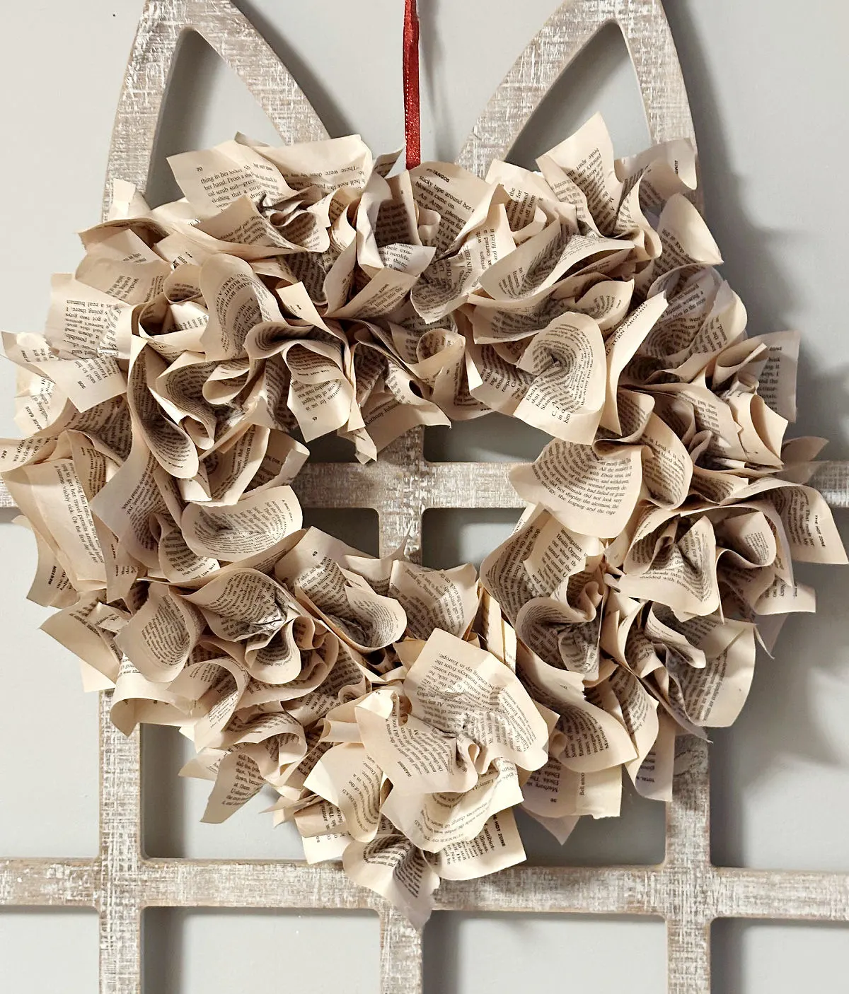 diy book page wreath hanging on arch