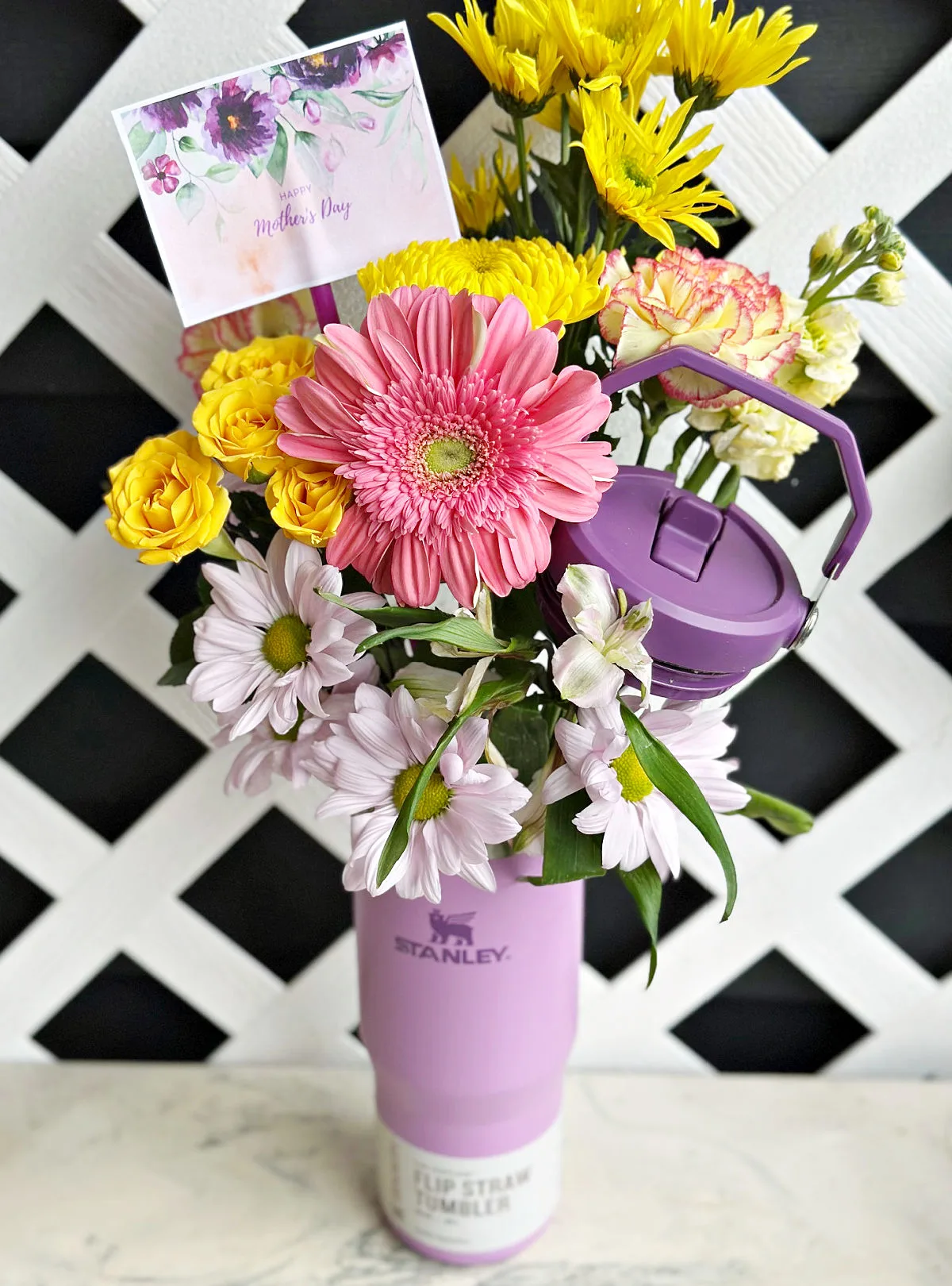 purple stanley cup with flowers and gift tag