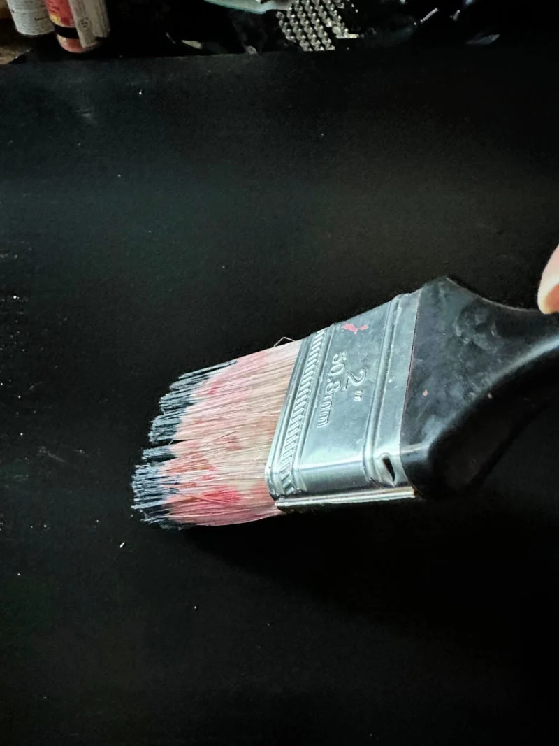 painting canvas with black acrylic paint