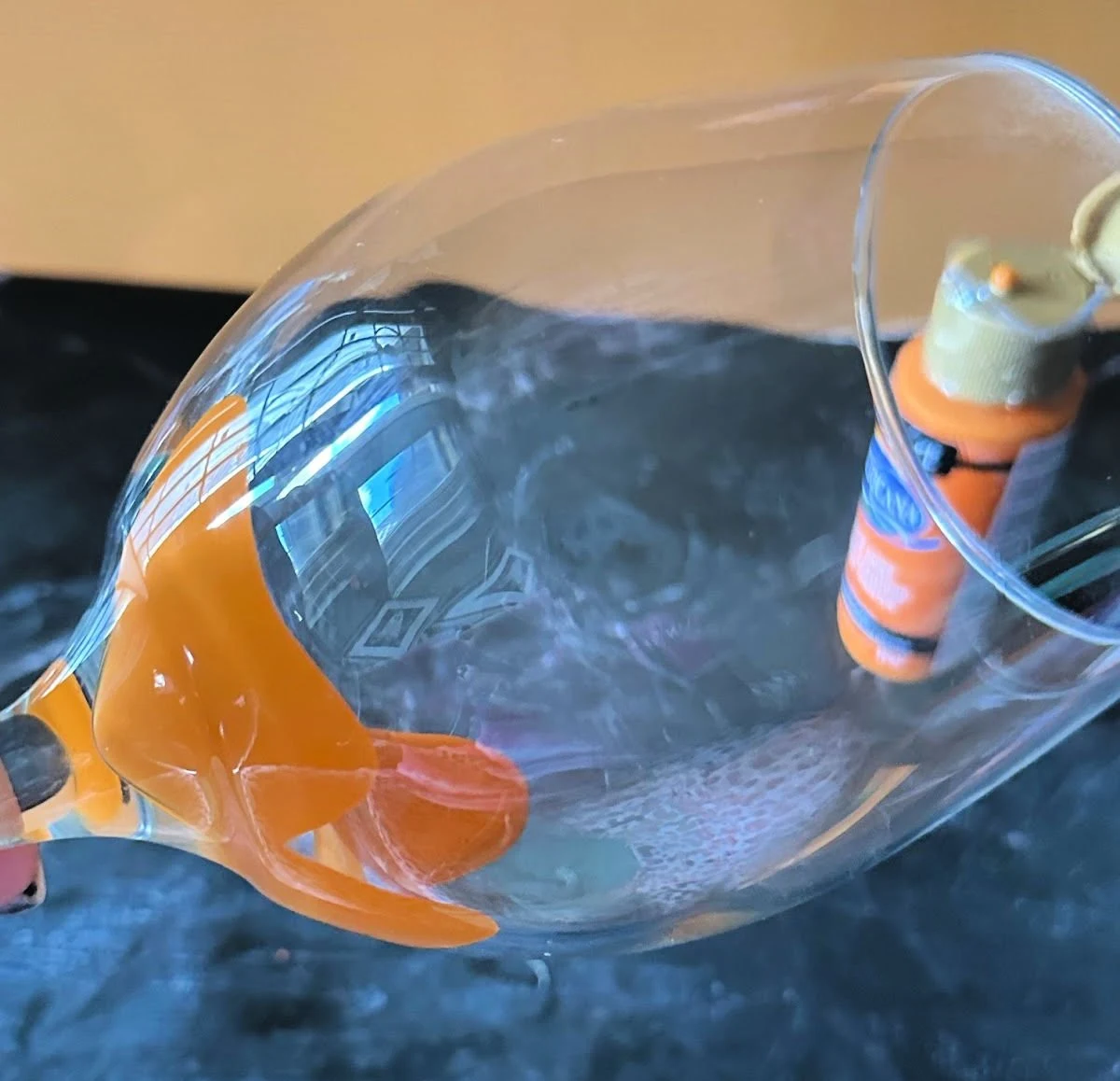 rolling paint on inside of wine glass