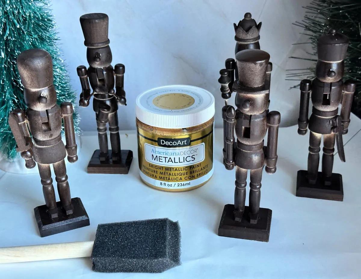 wood nutcrackers spray painted with brown spray paint