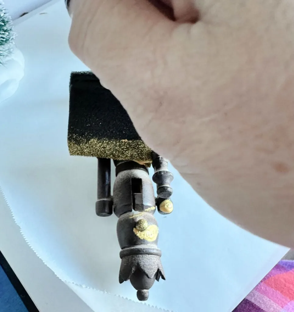 adding gold paint to wooden nutcrackers