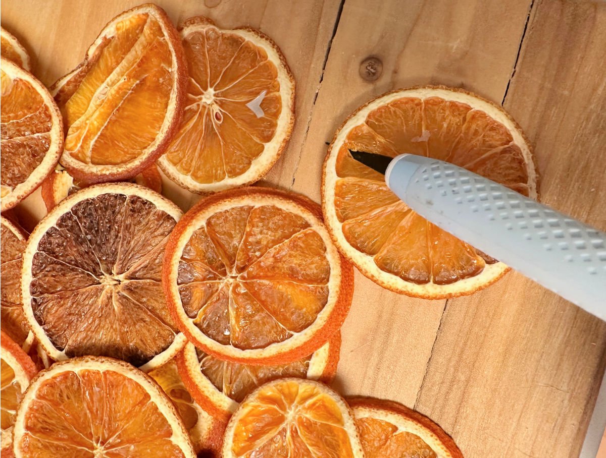 putting a hole in dried oranges for garland