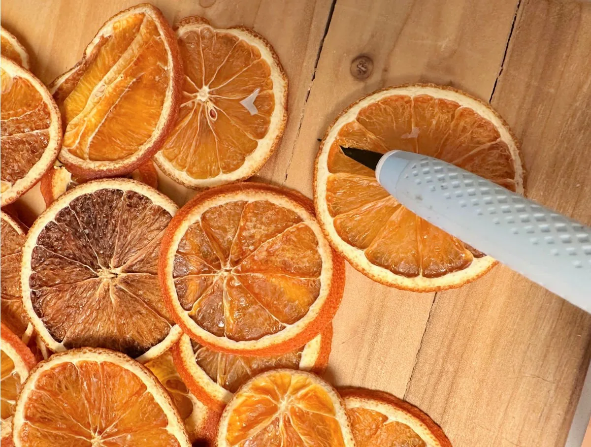 putting a hole in dried oranges for garland