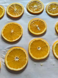 sliced oranges on parchment paper