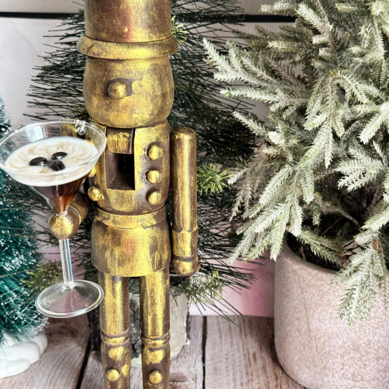 antique brass nutcracker holding espresso martini