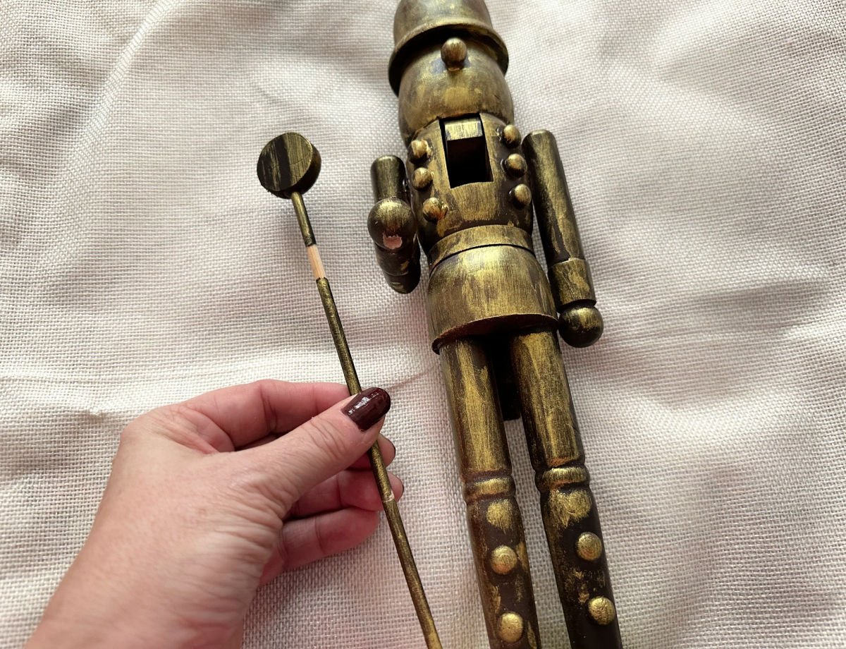 removing staff from painted nutcracker