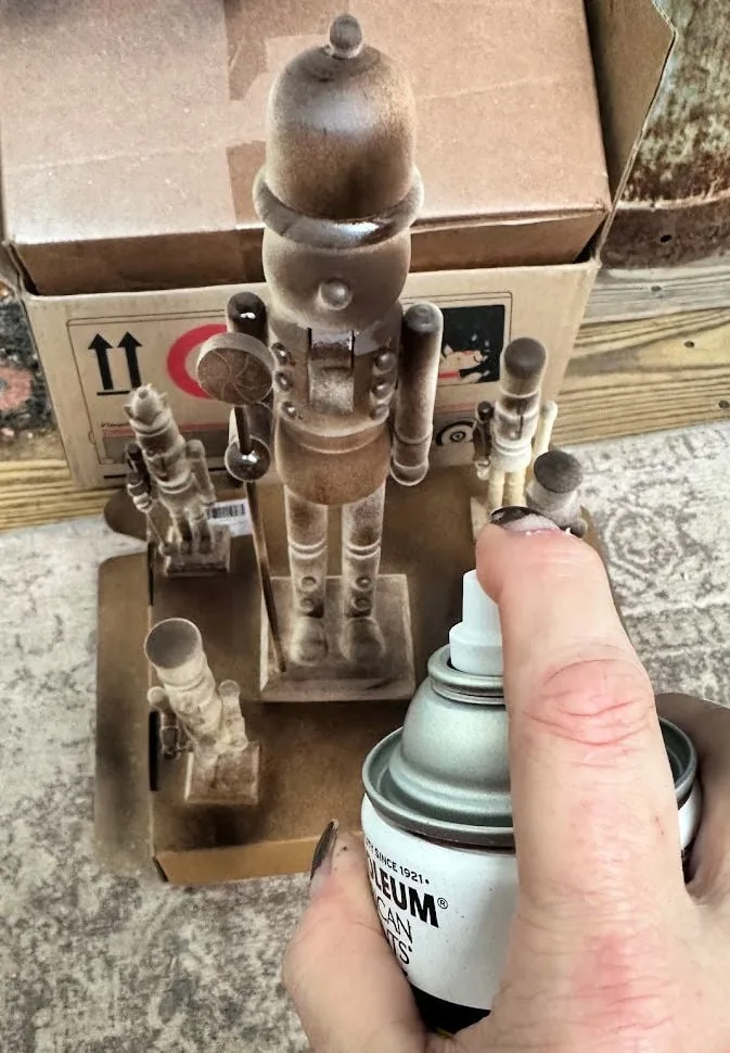 spray painting wood nutcracker with espresso spray paint