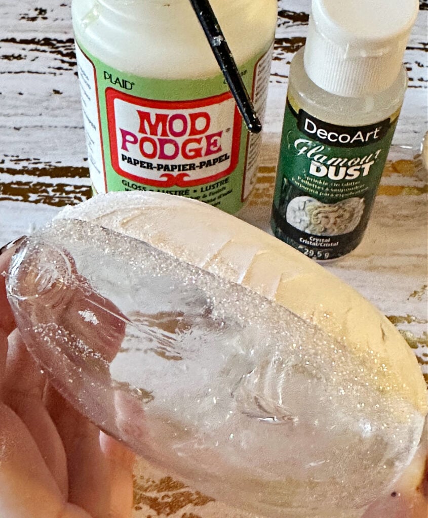 adding glamour dust to heart ornament