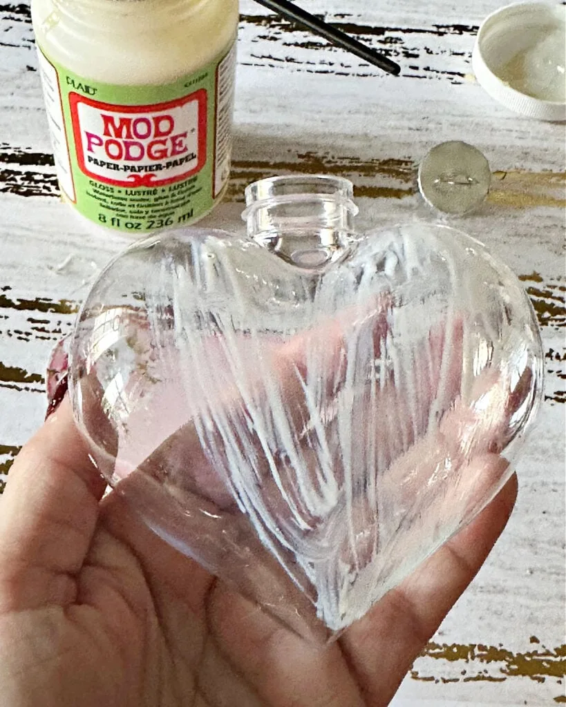 covering heart ornament with mod podge