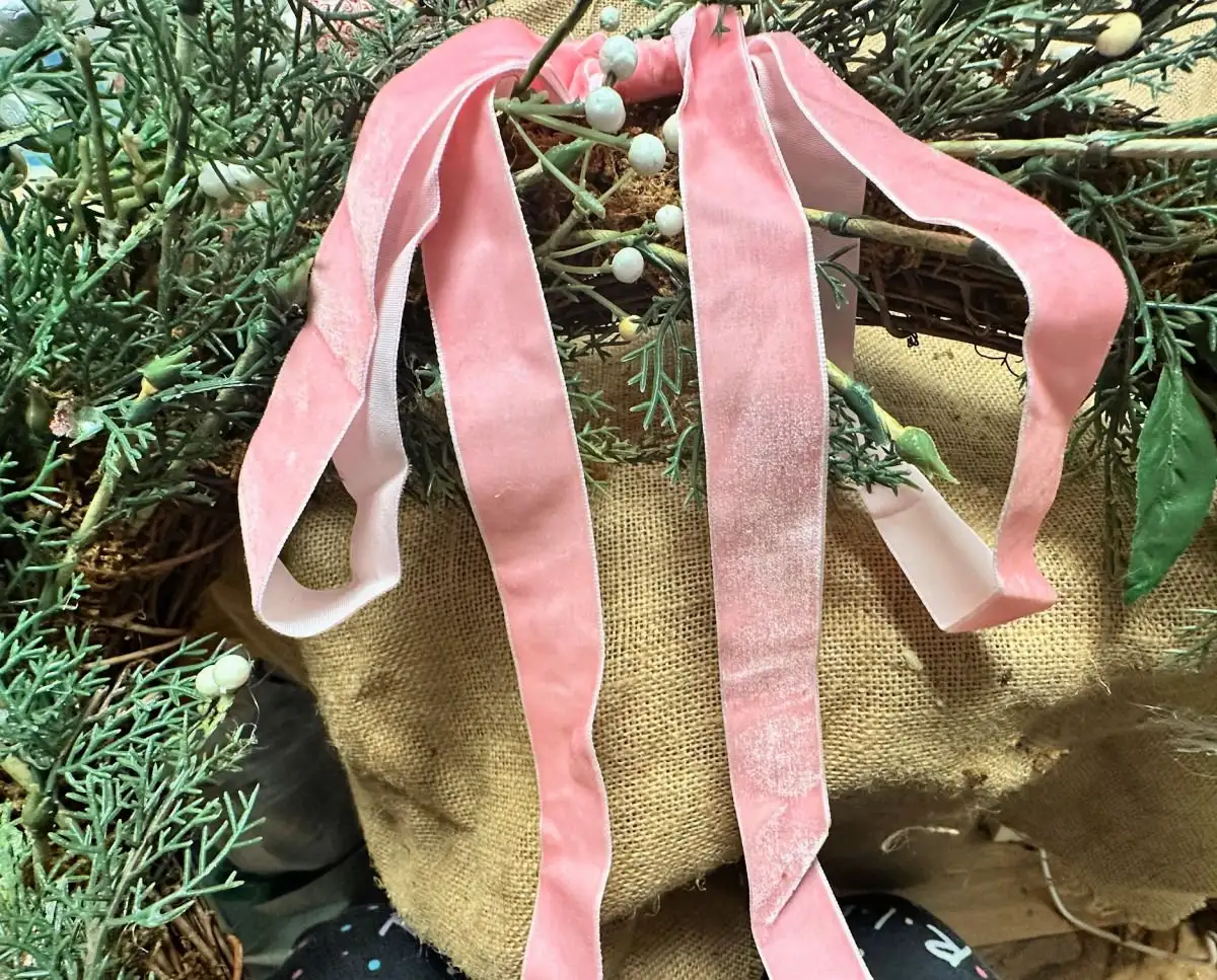 placing bow on wreath