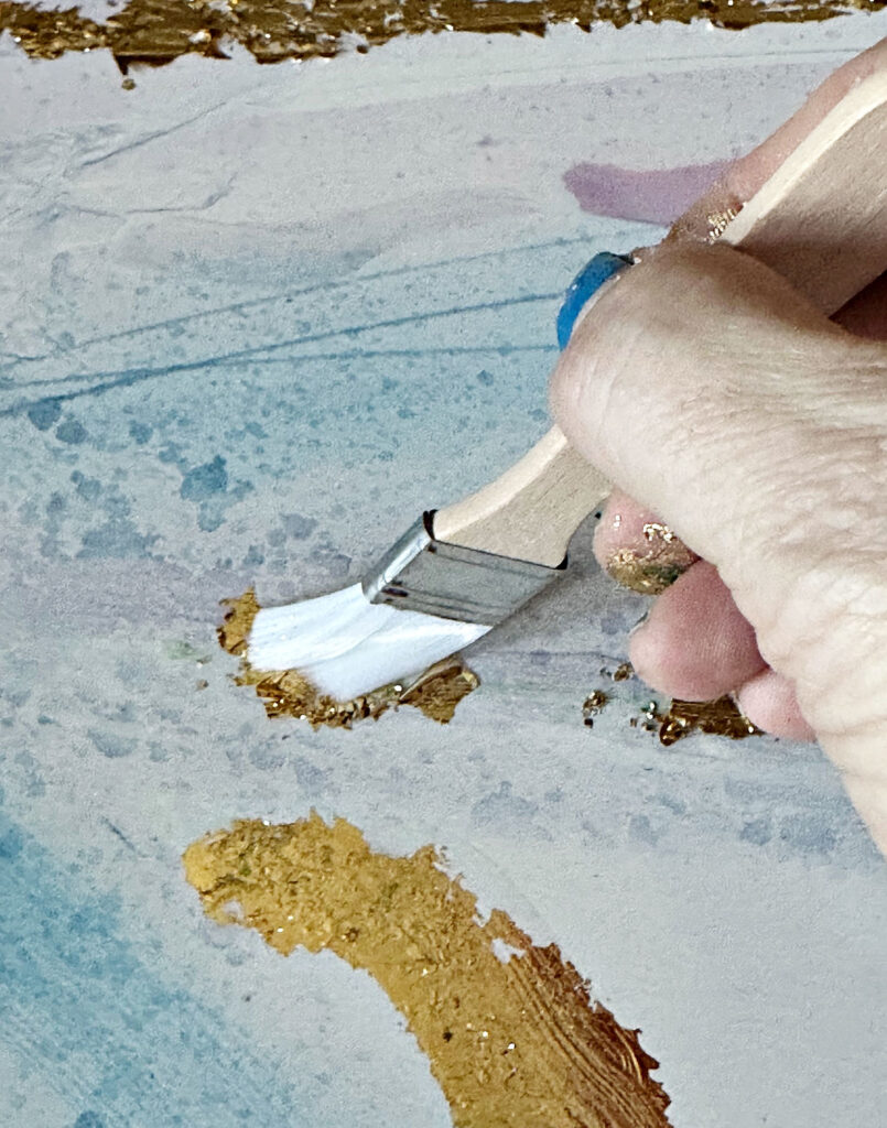 using brush to remove excess gold foil