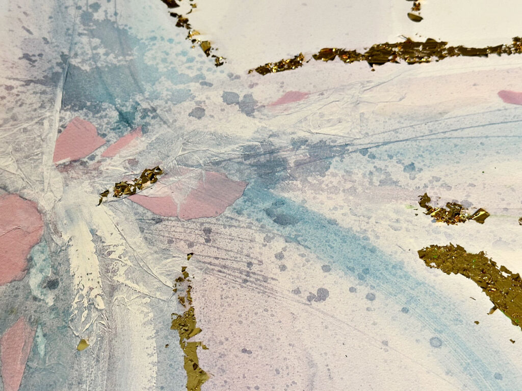 close up of thrift store art with gold foil