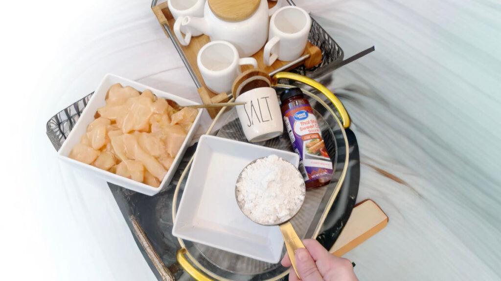 adding flour to chicken