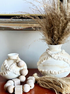 set of 2 thrift store clay vases shown with wood beads