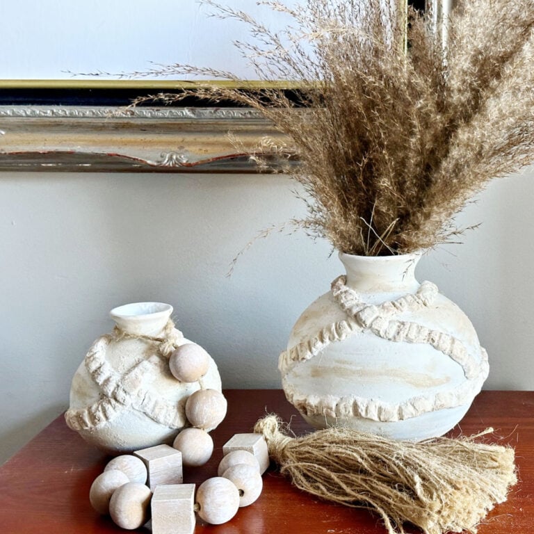 set of 2 thrift store clay vases shown with wood beads