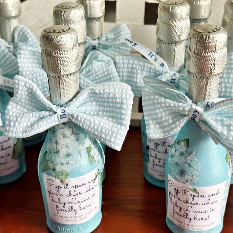 center view of mini prosecco bottles with blue striped bows painted baby blue