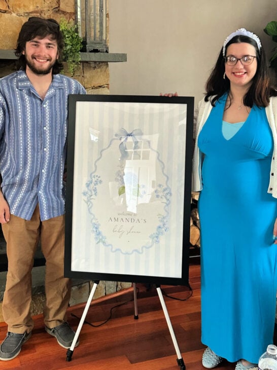 mom to be with welcome sign