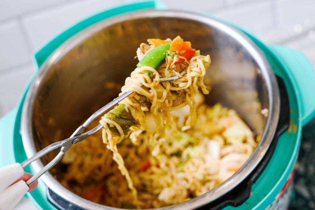 using tongs to remove ramen noodle stir fry from instant pot