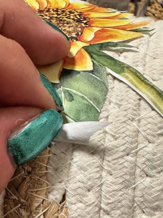 using mod podge to secure the sunflower to the basket