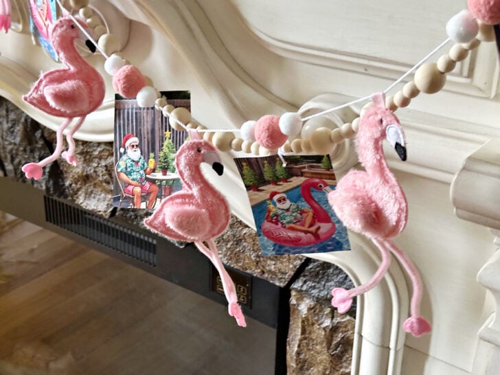 close up of pink flamingo garland on mantel for christmas in july