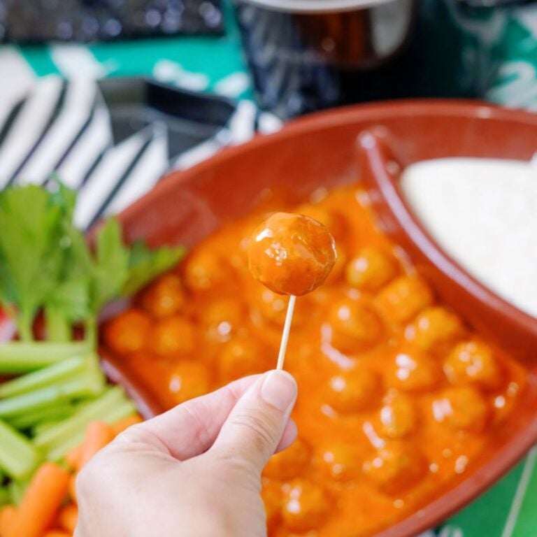 hand holding toothpick with buffalo meatball