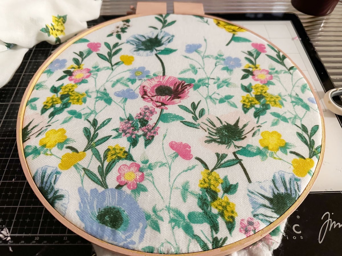 top view of thrift store scarf in embroidery hoop