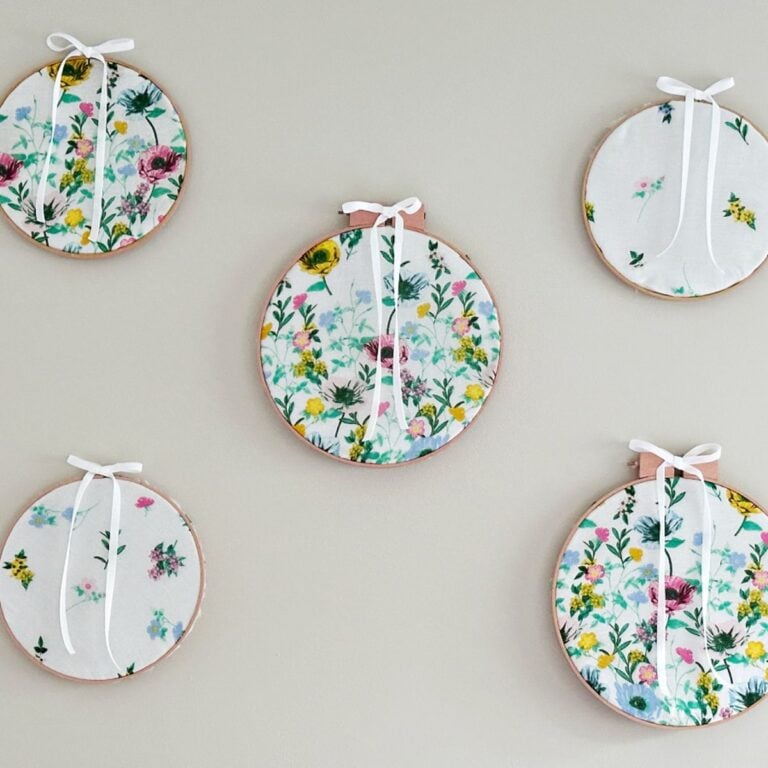 DIY Embroidery Hoop Wall Art above bed from thrifted finds