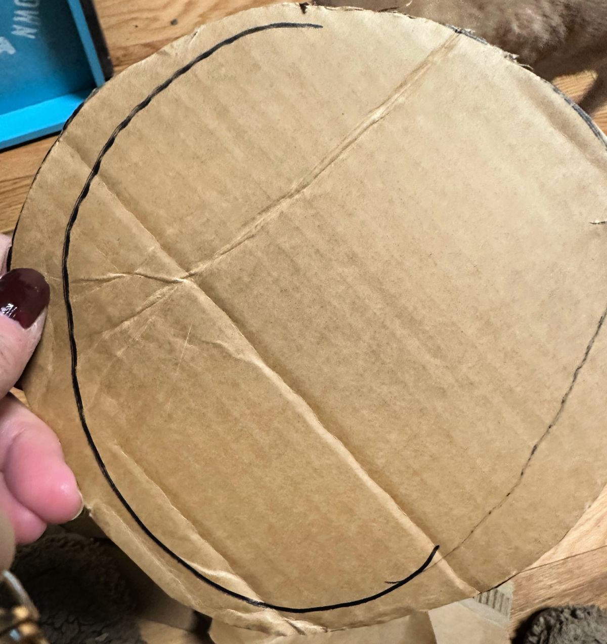 cutting out cardboard for witch hat