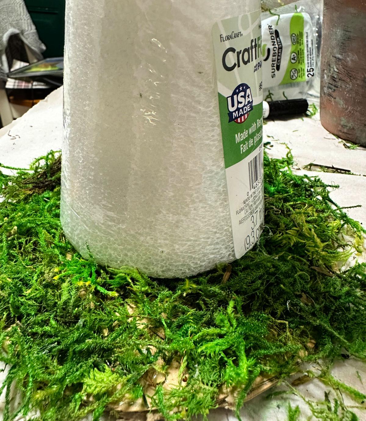 adding moss to cardboard circle for witch hat brim